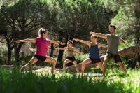 a group of people doing a yoga pose in the grass at Belambra Clubs Presqu&#39;île De Giens - Riviera Beach Club in Hyères