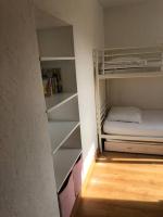 a small room with a bunk bed and shelves at Appartement A confortable et lumineux in Neufchâtel-Hardelot