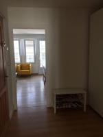 a living room with a yellow couch and a table at Appartement A confortable et lumineux in Neufchâtel-Hardelot