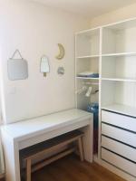 a white room with a desk and a closet at Appartement A confortable et lumineux in Neufchâtel-Hardelot