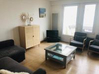 a living room with a couch and a coffee table at Appartement A confortable et lumineux in Neufchâtel-Hardelot