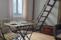 a table with a chair and a ladder in a room at Studio au coeur de Marseille in Marseille
