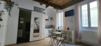 a kitchen with a table and chairs in a room at Studio au coeur de Marseille in Marseille