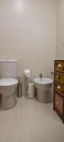 a white bathroom with a toilet and a sink at Apartamento Cerezo Beach in Xilxes