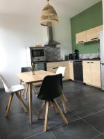 a kitchen with a wooden table and chairs in it at Appartement au cœur du Val d&#39;Argent in Sainte-Croix-aux-Mines