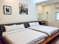 two beds sitting next to each other in a room at Lai Chi Te Hotel in Tainan