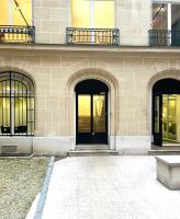 a building with three doors and a bench in front at [New] Eiffel tower view studio &#47; Paris Étoile in Paris