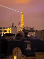 a view of the eiffel tower at night at [New] Eiffel tower view studio &#47; Paris Étoile in Paris