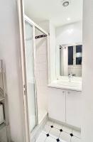 a white bathroom with a sink and a mirror at [New] Eiffel tower view studio &#47; Paris Étoile in Paris
