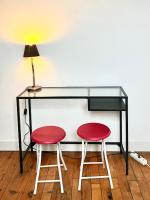 a desk with two red chairs and a lamp at [New] Eiffel tower view studio &#47; Paris Étoile in Paris