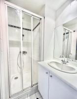 a white bathroom with a shower and a sink at [New] Eiffel tower view studio &#47; Paris Étoile in Paris