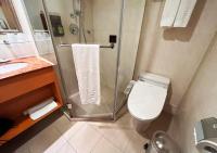 a bathroom with a shower and a toilet and a sink at Fuward Hotel Tainan in Tainan