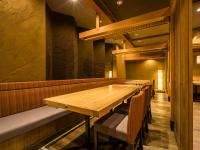 a dining room with a wooden table and chairs at Japanese Onsen Ryokan Kohakuen in Fuefuki