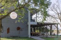 a building with a pavilion with tables and a tree at 輕塵別院Serenegray B&amp;B in Wujie