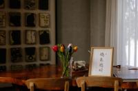 a table with a vase of flowers and a picture at 輕塵別院Serenegray B&amp;B in Wujie
