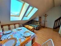 a living room with a table and some windows at Studio Samoëns, 1 pièce, 4 personnes - FR-1-624-58 in Samoëns