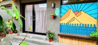 a house with a door with a mountain mural on it at Taipei Jinguashi Cloud Mountain Homestay B&amp;B in Jiufen