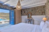 A bed or beds in a room at Lkm 4 Bed Villa Air Panormos Mykonos