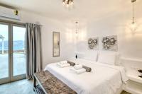A bed or beds in a room at Lkm 4 Bed Villa Air Panormos Mykonos
