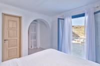 A bed or beds in a room at Lkm 4 Bed Villa Air Panormos Mykonos