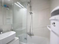 a white bathroom with a shower and a sink at Appartement Les Gets, 3 pièces, 4 personnes - FR-1-623-292 in Les Gets