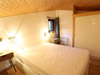 a bedroom with a white bed and a wooden ceiling at Appartement Les Gets, 3 pièces, 4 personnes - FR-1-623-292 in Les Gets
