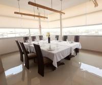 a dining room with a long table and chairs at Hotel Ceibo Dorado in Portoviejo