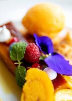 a pile of fruit and flowers on a plate at Hotel Porta do Sol Conference & SPA in Caminha