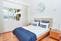 A bed or beds in a room at Stunning Villa with Breathtaking Ocean View