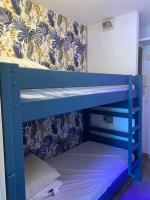 two bunk beds in a room with a wall at 5 min du bord de mer in Hyères