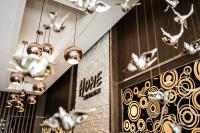 a restaurant with chandeliers and skulls on the wall at Global Traveler Hotel in Kaohsiung