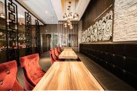 a restaurant with a wooden table and red chairs at Global Traveler Hotel in Kaohsiung