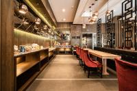 a restaurant with wooden tables and red chairs at Global Traveler Hotel in Kaohsiung