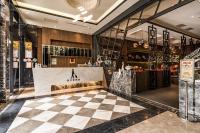 a restaurant with a checkered floor in a store at Global Traveler Hotel in Kaohsiung