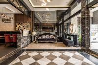 a living room with a couch and a checkerboard floor at Global Traveler Hotel in Kaohsiung