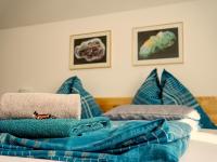 a pile of blue pillows on a bed at Gasthof zum Postwirt in Predlitz