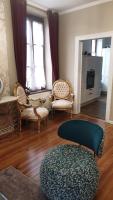 a living room with chairs and a ottoman at Le LOUIS XV halte romantique à Metz centre in Metz