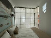a bedroom with a bed and a large window at FELIX FAURE PALAIS DES FESTIVALS CROISETTE VIEUX PORT in Cannes