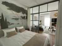 a bedroom with a white bed and a large window at FELIX FAURE PALAIS DES FESTIVALS CROISETTE VIEUX PORT in Cannes