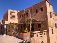 a building with a sign in front of it at Les 4 Saisons Du Dades in Aït Idaïr