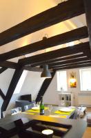 a dining room table with a bottle of wine on it at Bretzel &amp; Raisin - Hypercentre de Colmar in Colmar