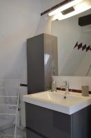 a bathroom with a sink and a mirror at Bretzel &amp; Raisin - Hypercentre de Colmar in Colmar