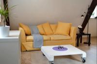 a living room with a yellow couch and a coffee table at Bretzel &amp; Raisin - Hypercentre de Colmar in Colmar