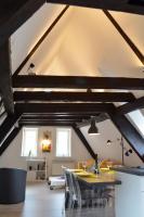 a room with a table and chairs in a attic at Bretzel &amp; Raisin - Hypercentre de Colmar in Colmar