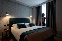 A bed or beds in a room at Duomo Hotel & Apartments