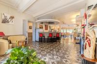 a living room with a bar and a dining area at Logis Hôtel Restaurant des Corbières in Lagrasse