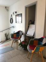 a room with two chairs and a sign on the wall at Hôtel Le Relais in Fleurance