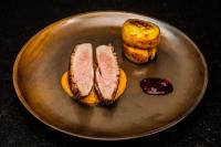 two slices of meat on a plate with bread at Hotel Beskid BALNEO Medical Resort & SPA in Piwniczna