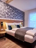 A bed or beds in a room at Laudach INN