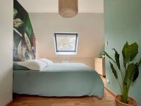 a bedroom with a blue bed and a potted plant at Premium holiday home in top location with sea view, Plougasnou in Plougasnou